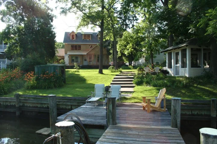 During: the rear of the home takes shape. Notice the bumpout on the left which provides a breakfast nook, and the bumpout on the right which makes the family room larger and brighter, with its bowed wall of windows and transoms.