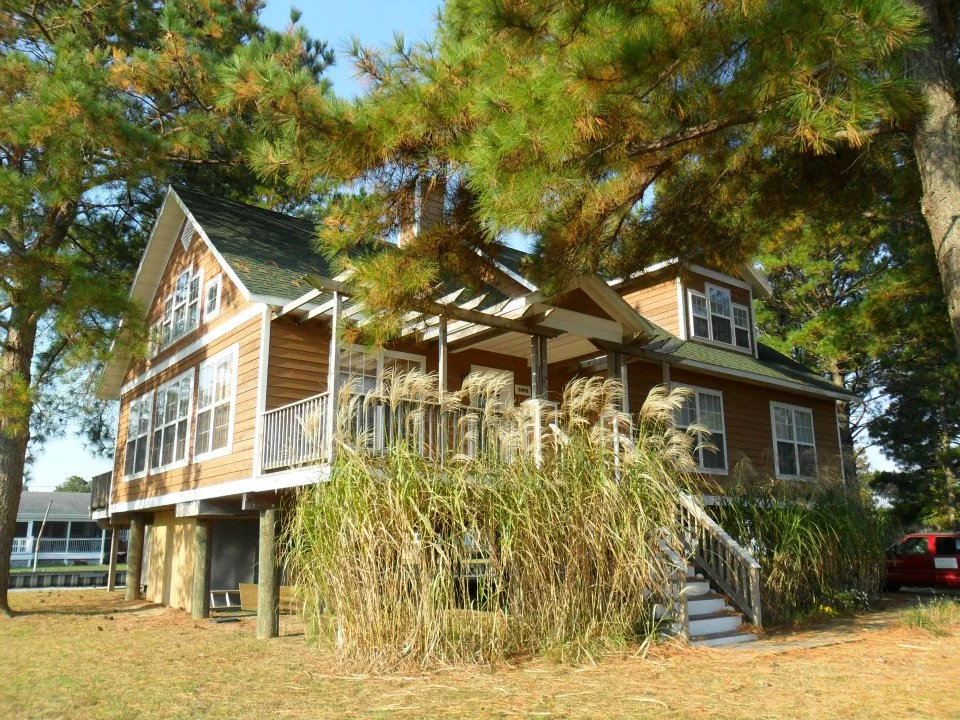 The left elevation looks up the canal toward the bay.