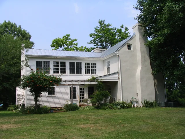 After: the owner wanted the second story to look like it was originally a covered porch that had been enclosed, with windows filling in the spaces between original porch posts. The twin windows on the left are in a new bathroom; the other three sets are in a sunroom accessible from the original and more recent second story wings.