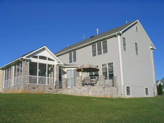Great new outdoor spaces on this house - sunroom, screened porch, and patio.