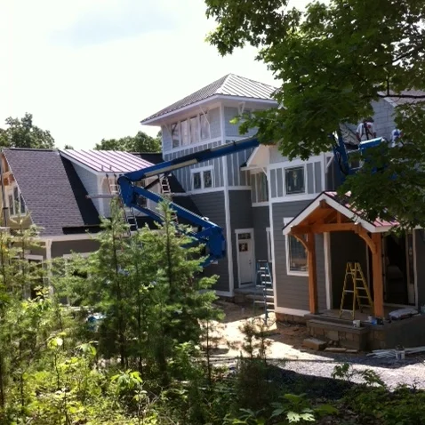 Now it's getting exciting! Standing seam metal has been installed, siding is being painted, and stone is being laid. 