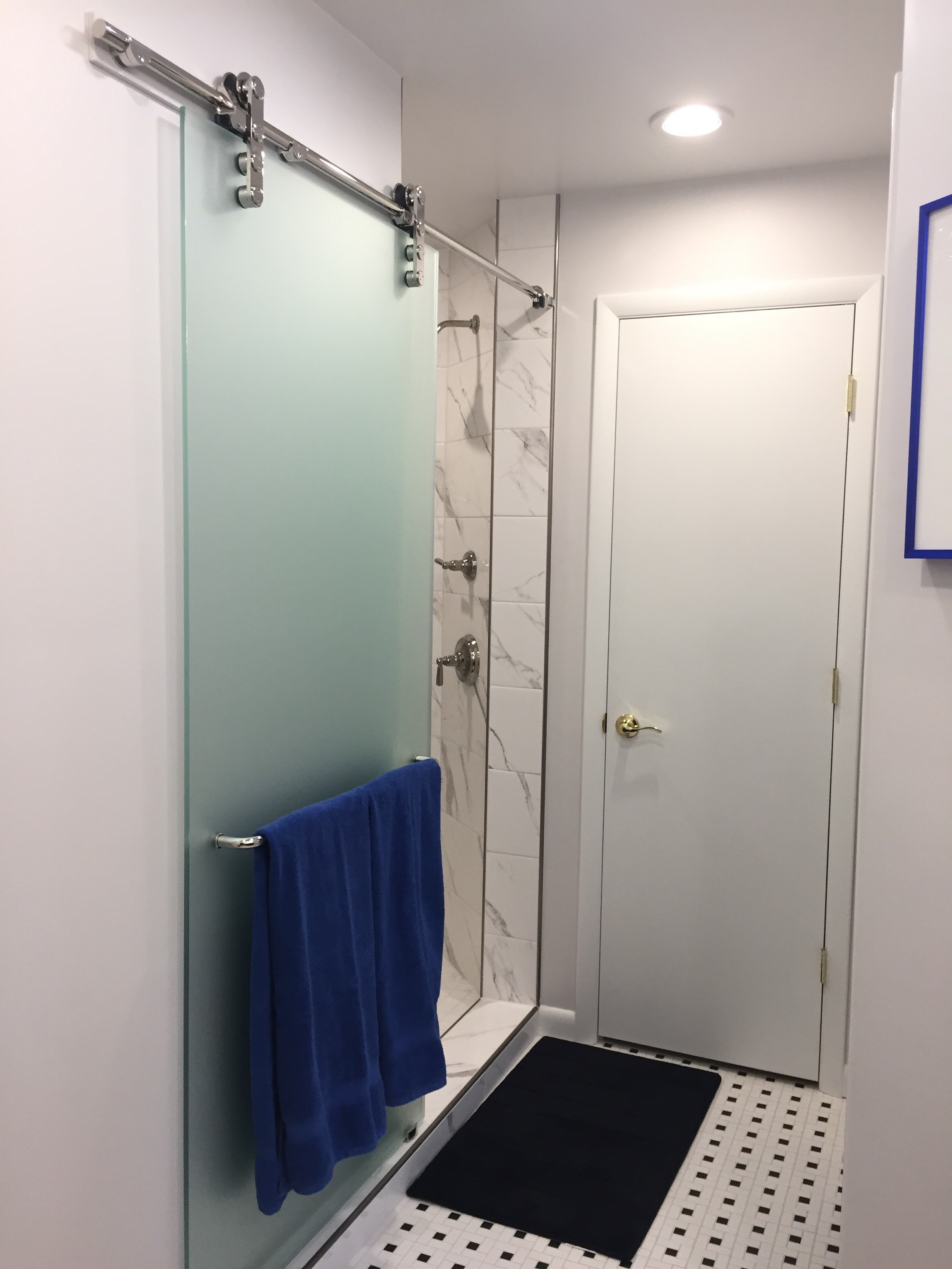  After, a large shower's door is mounted on contemporary barn door hardware to keep it out of the way.&nbsp; A new linen closet is at the end of the bathroom.&nbsp; The door to the toilet is out of sight, just to the right (opposite the shower).&nbsp