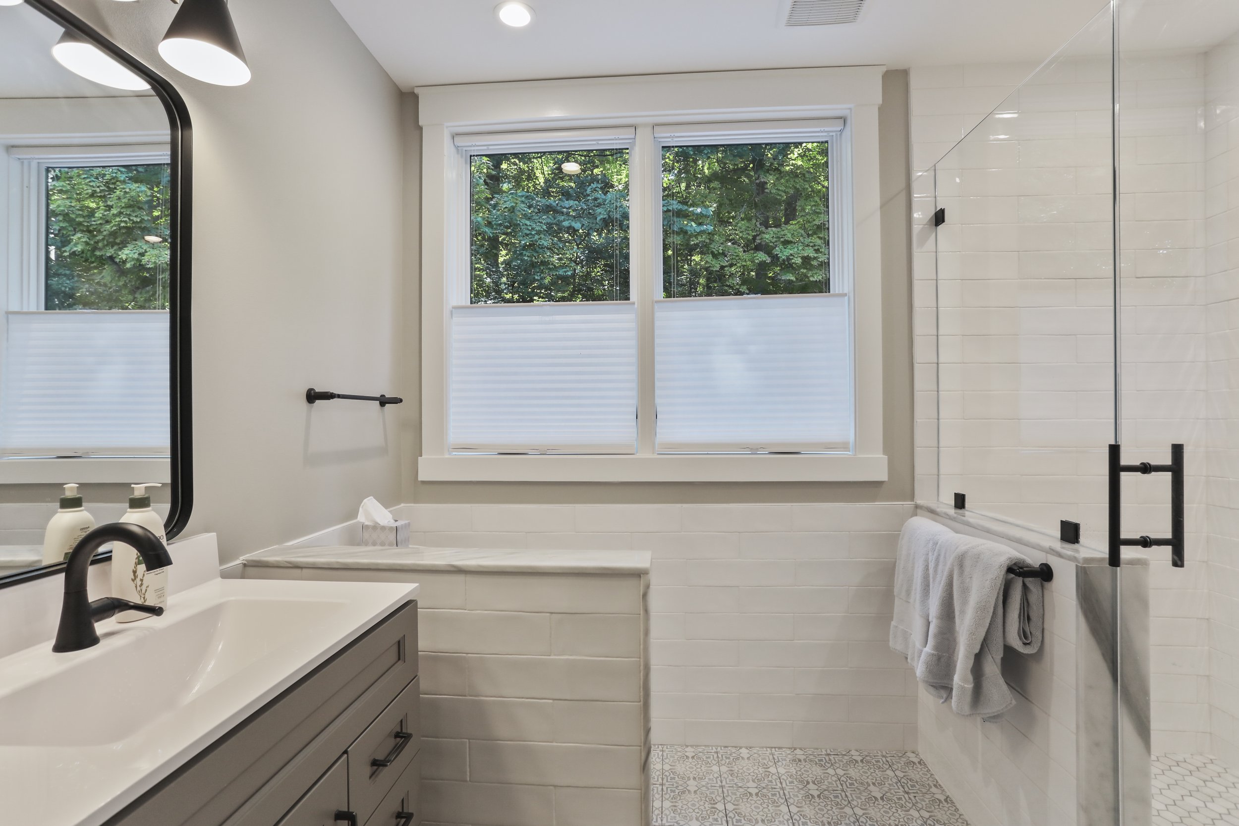  AFTER:  The new master bath is in the original kitchen’s location.  Triangle windows were removed, and new casement windows are centered on the gable.  Above the flat ceiling is a ledge so that the high transom window is visible from the bedroom sid