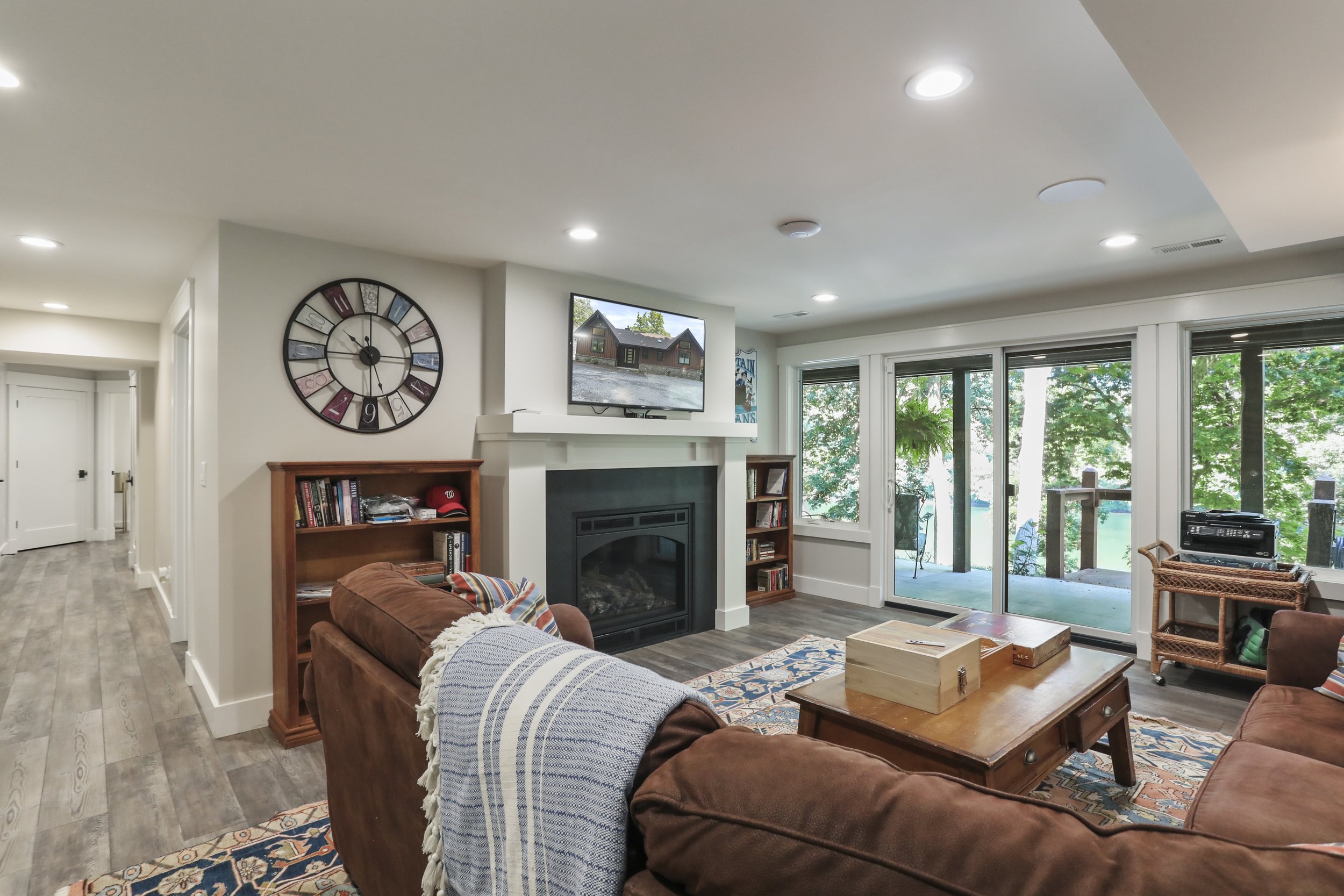  Remodeled family room included a new fireplace, doors, and windows.  Hallway leads to the new part of the home and the stairs. 