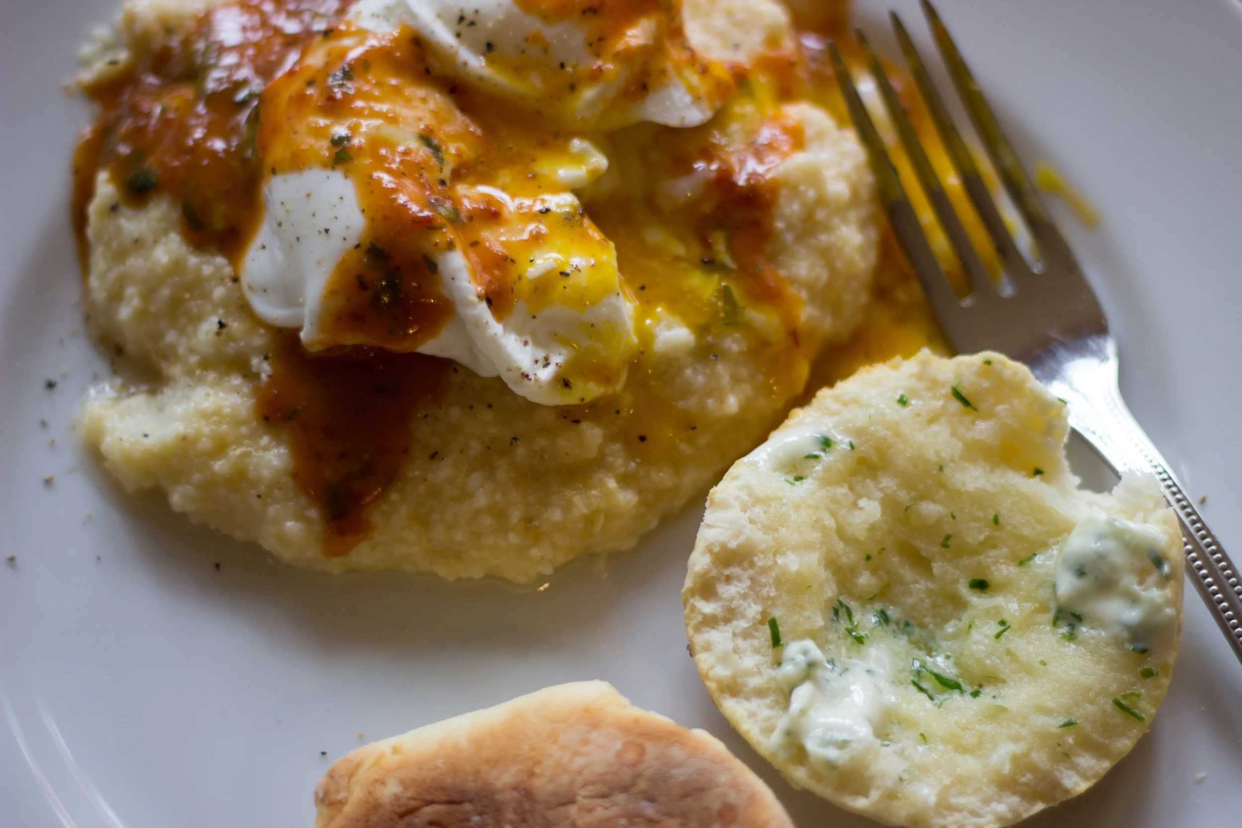 cheese grits topped with a poached egg and drizzled with chipotle sauce (recipe to come in the near future) + buttermilk biscuits with chive butter