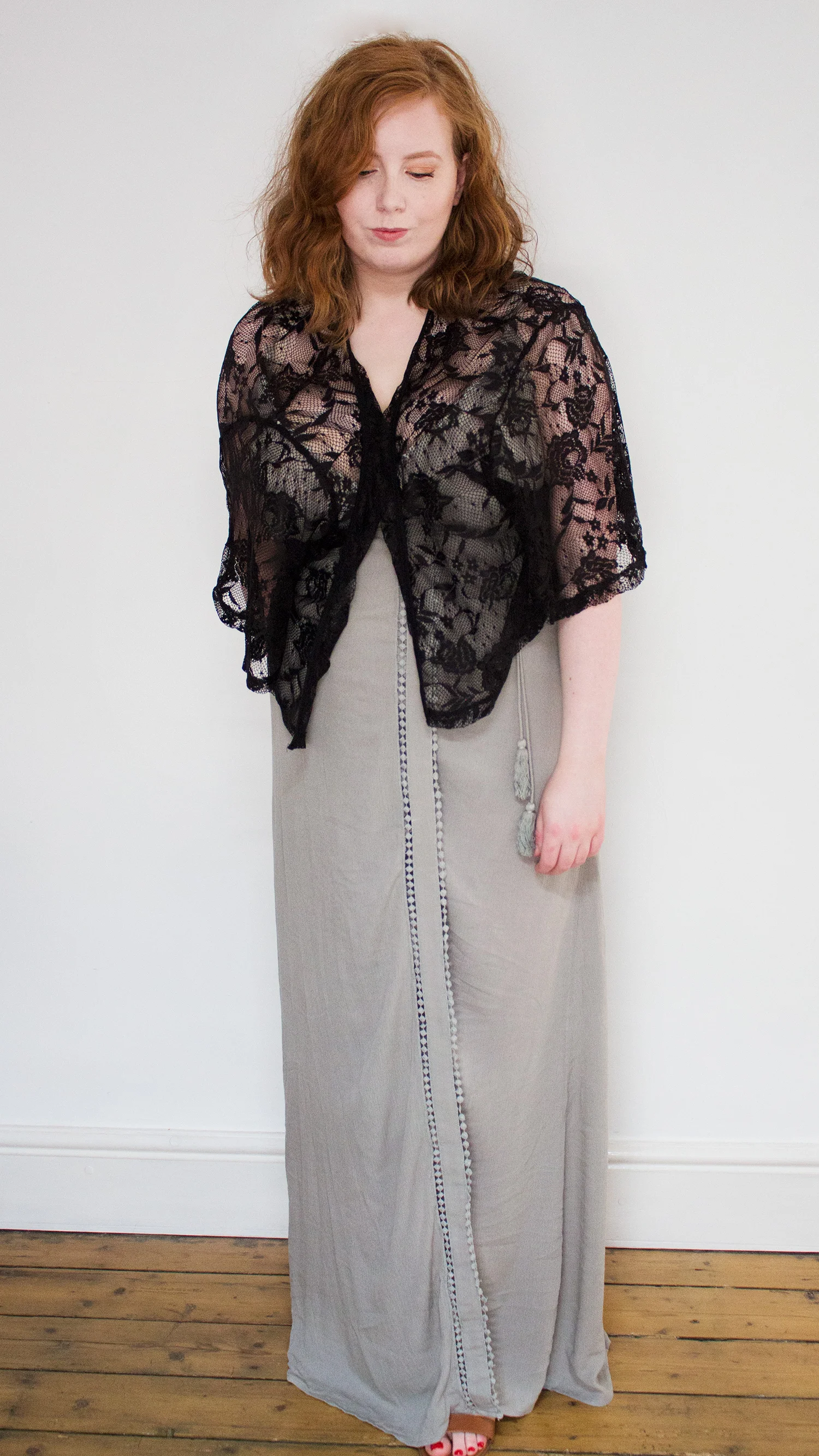 Woman in olive maxi dress and black kimono with brown sandals