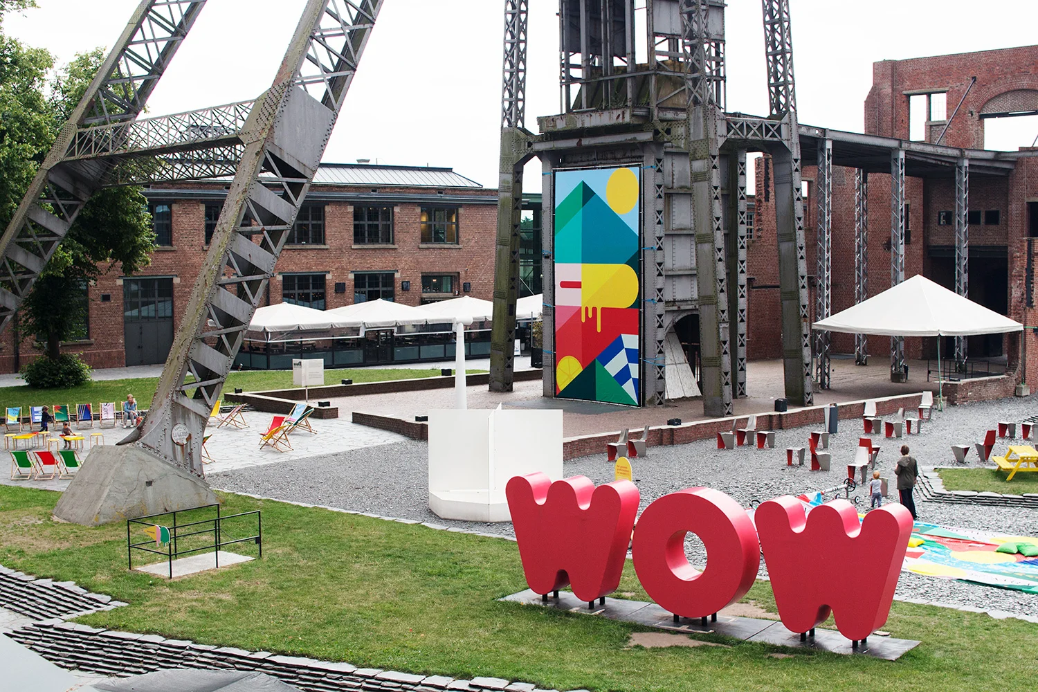 C-mine in Genk, with colourful exhibition in the garden and red giant letters saying "WOW"