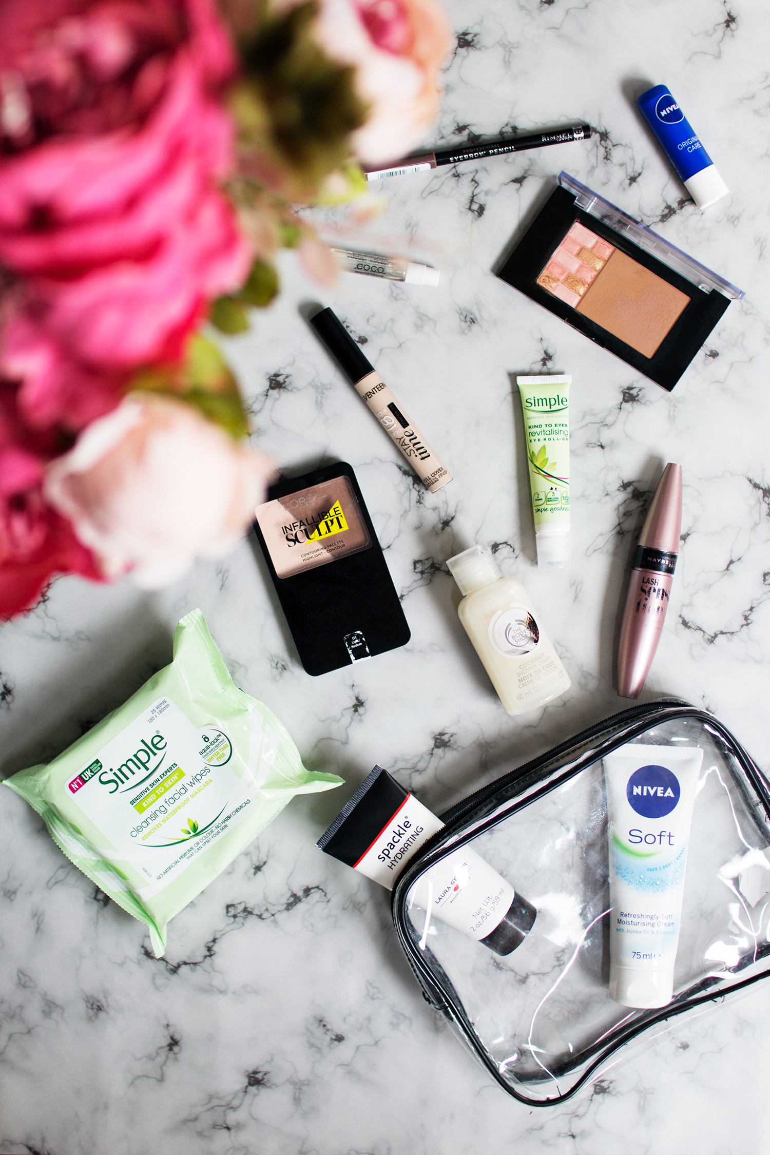 Image of makeup and skincare flatlay on marble