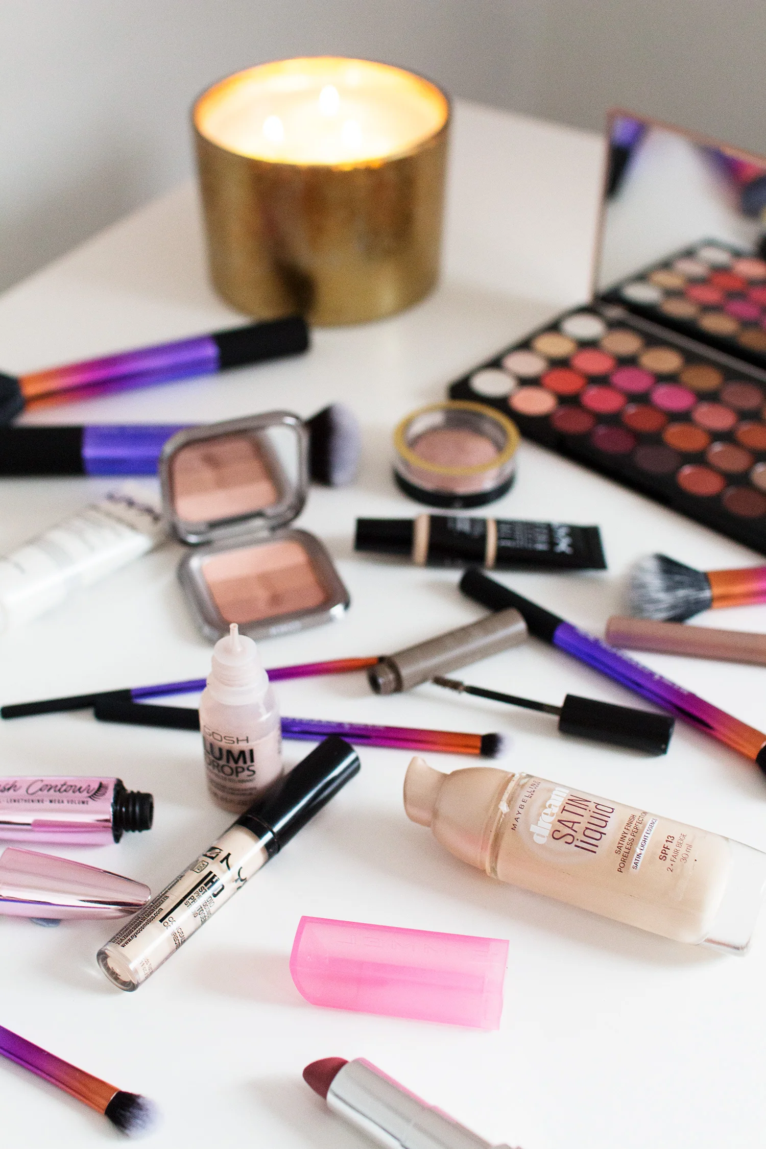 Makeup flatlay featuring the Makeup Revolution Flawless 4 palette, Max Factor Creme Puff Blush in Nude Mauve, NYX Gotcha Covered Concealer in Alabaster and Kiko Trio Blush in 02 Sand. Photography by Alice Red.