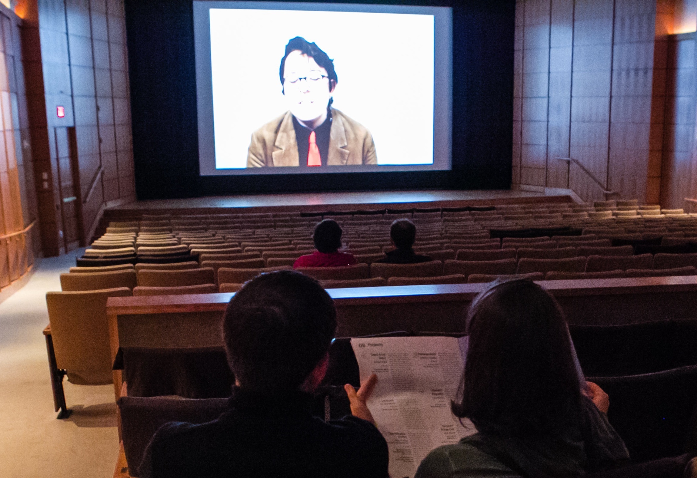  Museum vistors watching the film loop of the recordings from the night of the show. 