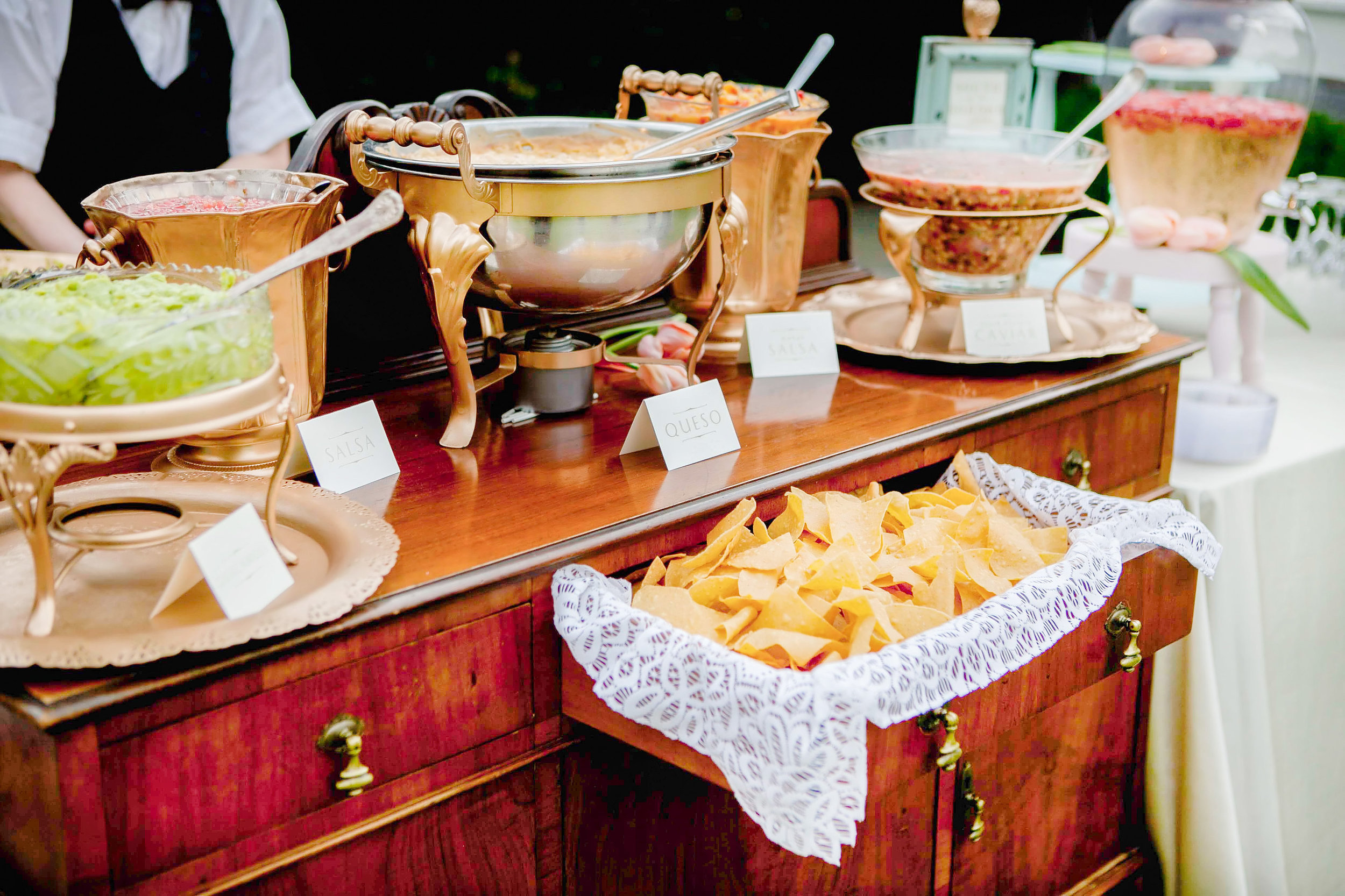 A south of the border station with fresh tortilla chips, a variety of salsas, queso. it also included a chef preparing fresh guacamole for guests and was made complete with red and white wine sangria.