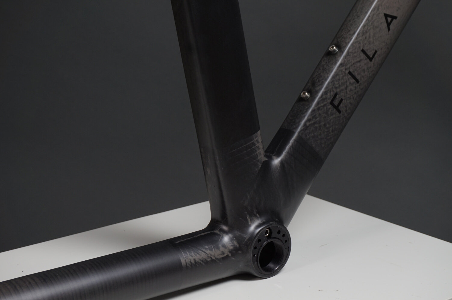 Close up of Filament's carbon fibre tubes and joints for an aero TT frameset. Eccentric bottom bracket.