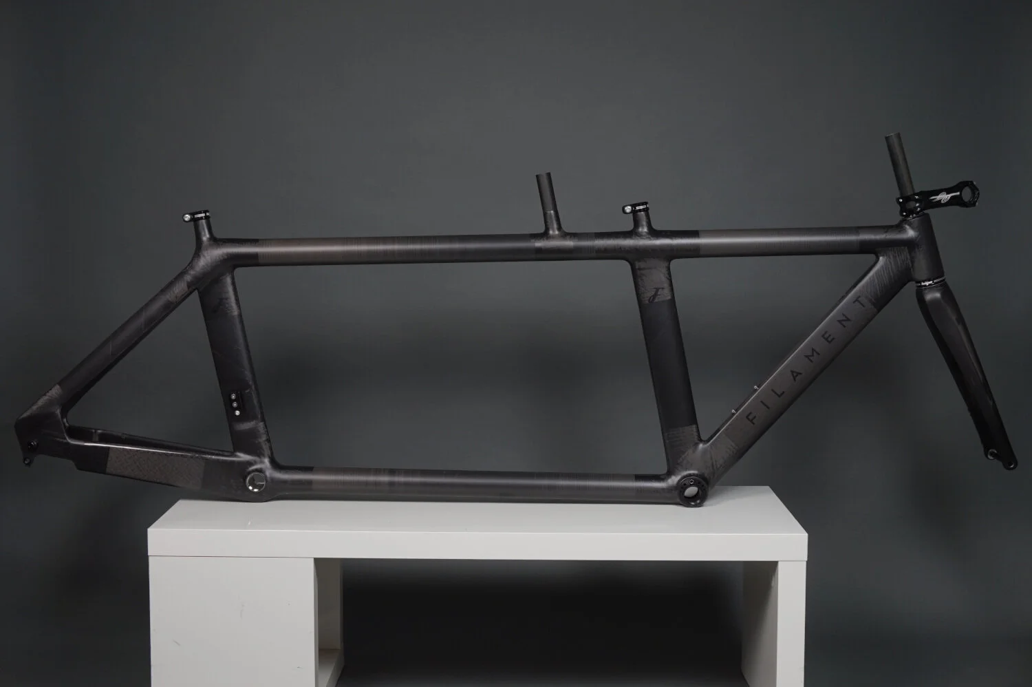 Side profile image of a Filament aero time trial bike highlighting the custom geometry of the frame benefitting both stoker and pilot.