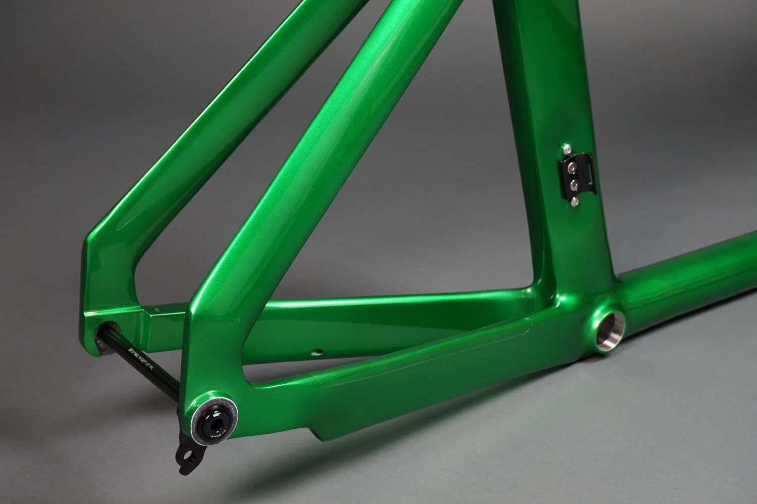 Close up of disc brake dropouts with thru-axle and SRAM UDH on a Filament triathlon bike frame.