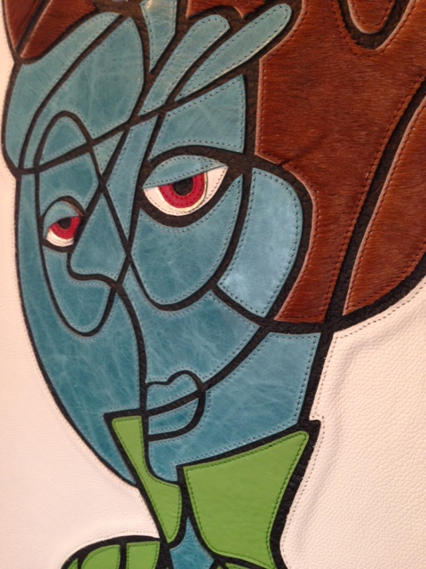 Leather and thread on wood.