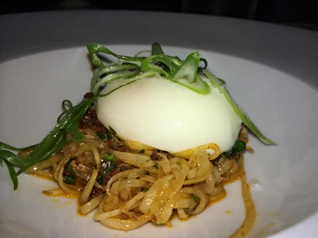 "Huertas Rotos", potato strands, chorizo vinaigrette, and a slow poached egg.