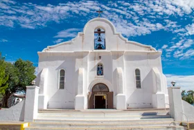 The beautiful white adobe exterior of the Presidio Chapel in San Elizario is an iconic fixture of the famous Mission Trail.&nbsp;