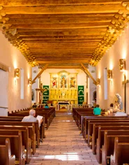 The Socorro Mission church attracts visitors with its golden altar and wooden structures.
