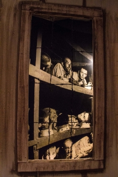 A haunting life-sized picture of victims in Europe’s many concentration camps during World War II is placed behind a model camp, giving it a life-like quality.