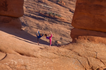 A mother-daughter duo strike a pose under the Delicate Arch in Utah’s Arches National Park. People take pictures under the arch as the mile-and-a-half hike to the summit makes for a once in a lifetime experience.