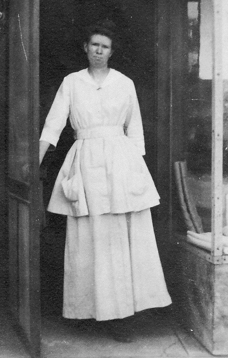 Mamie Sala in front of her needlework store, Gridley California
