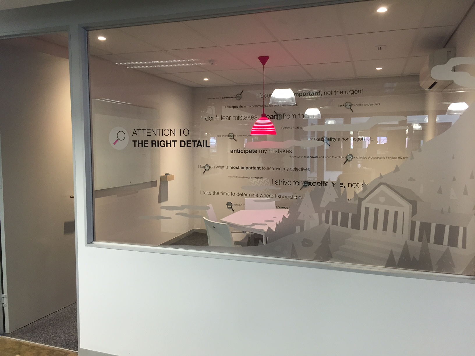 We pay attention to the right detail. Those are magnifying glasses and a statement of this value's associated behaviours on the back wall. This is our strategic value. We take time to think about what detail to pay attention to, and once we have made a decision, we act with purpose. 
