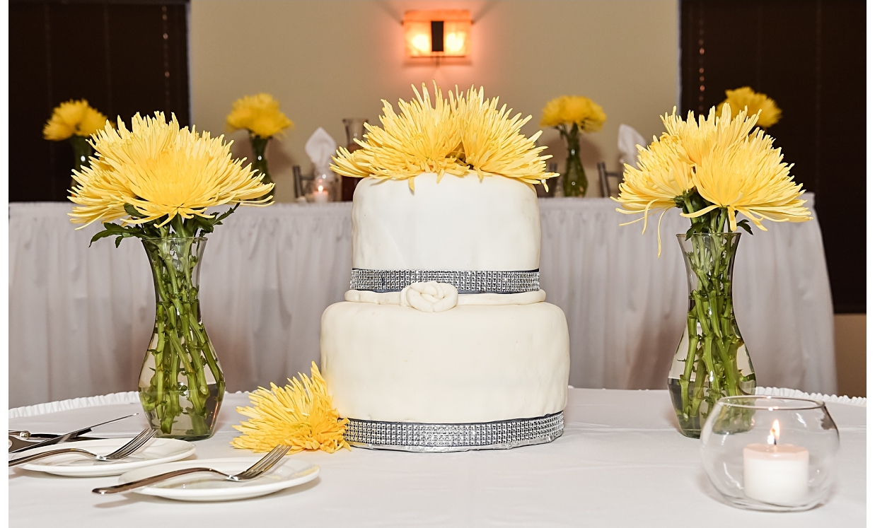"We purchased the flowers from East Chicago Florist . Then we arranged the centerpieces ourselves with the help from of some of our bridal party. I chose spider mums because they remind me of fireworks and I love their modern appeal."