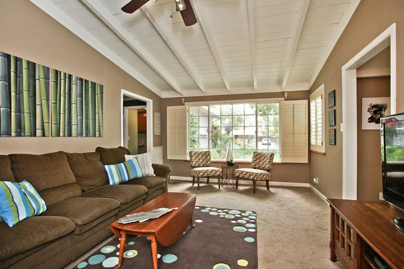 AFTER: The living room is tidy, bright, and neutral