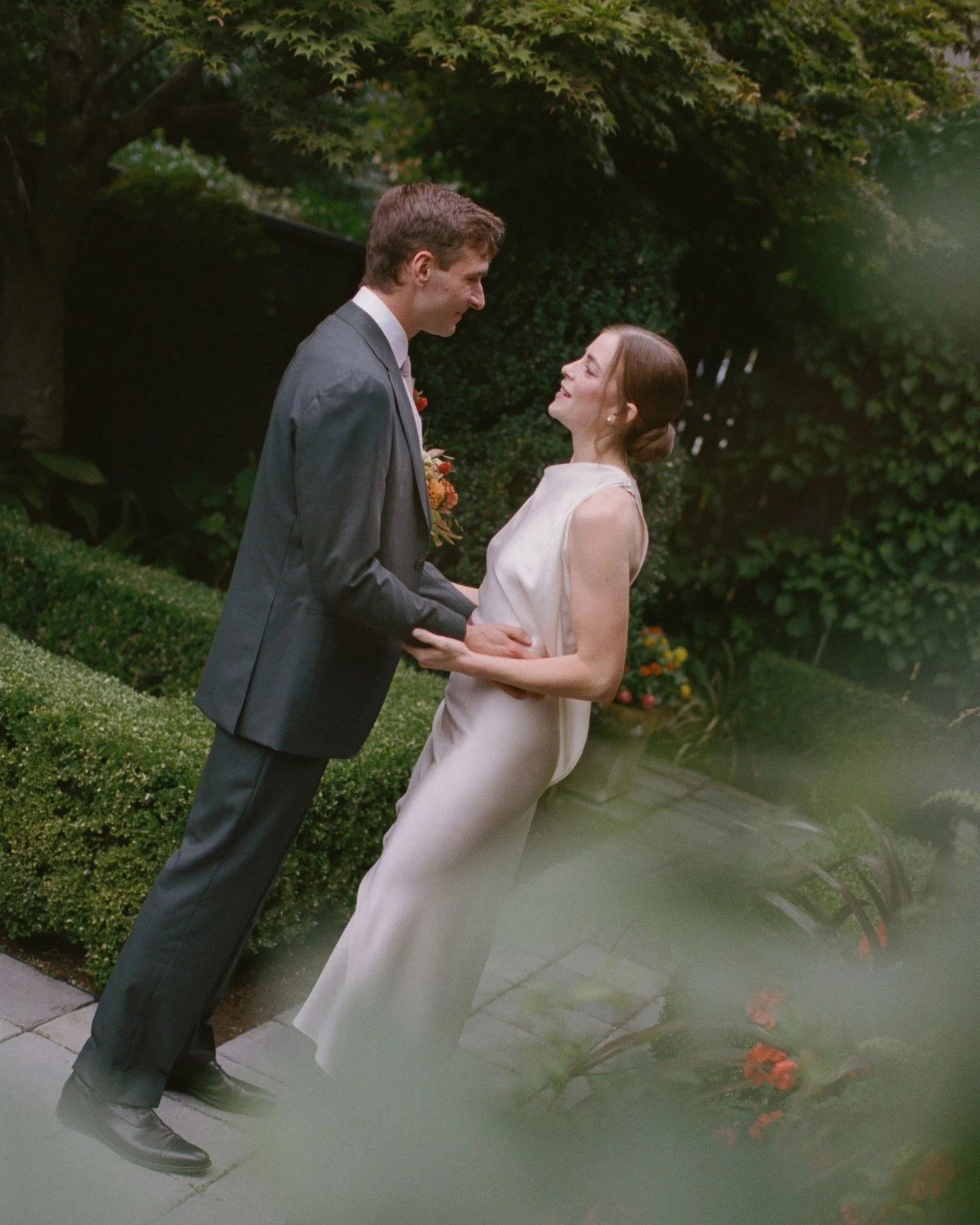 E +M celebrated their marriage with a Seattle backyard wedding at her family's home overlooking the water. Their gentle and elegant energy set the tone for poetic vows, toasts that elicited tears, and the beginning of two families blending together. 