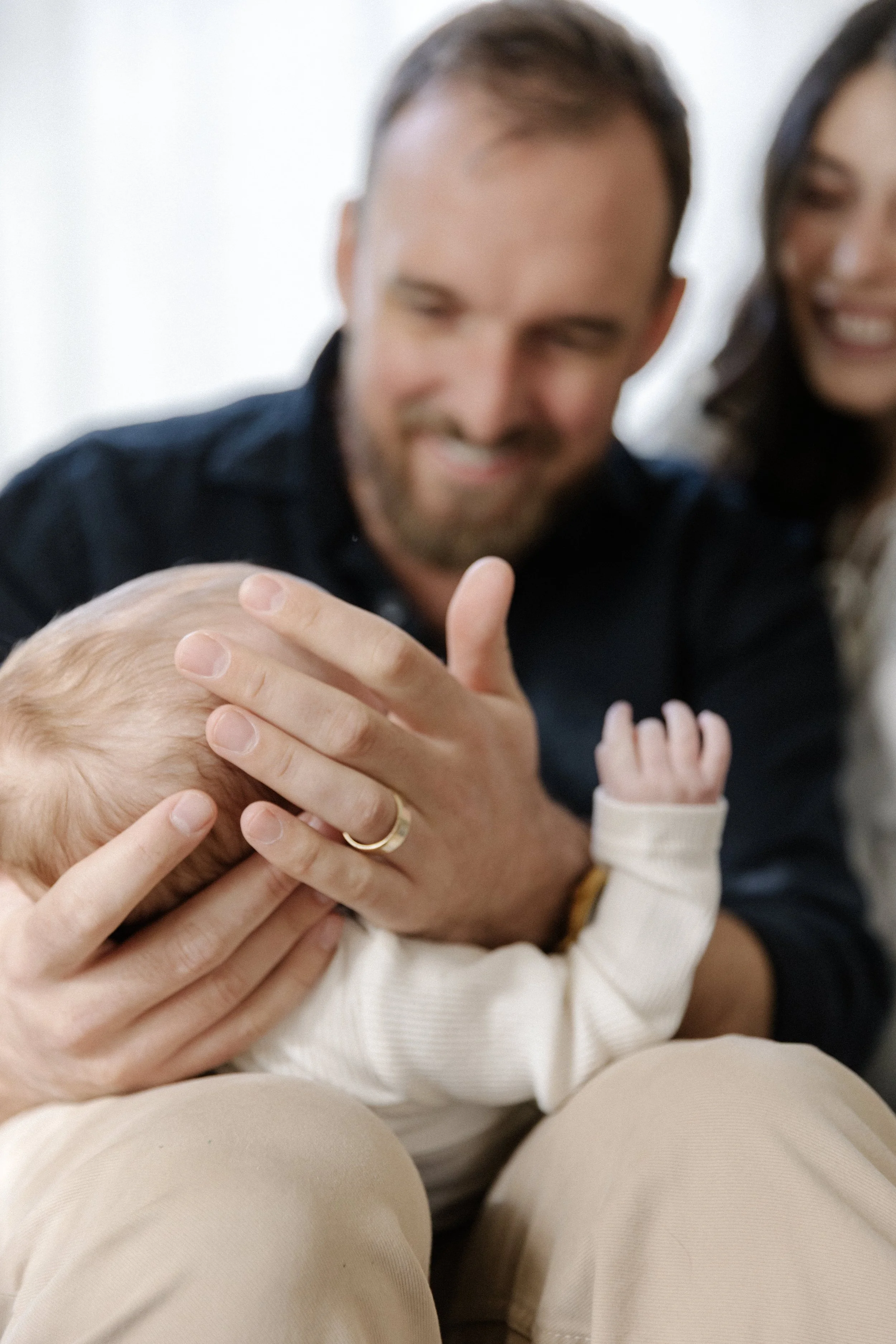 Seattle newborn family photography with parents admiring their baby