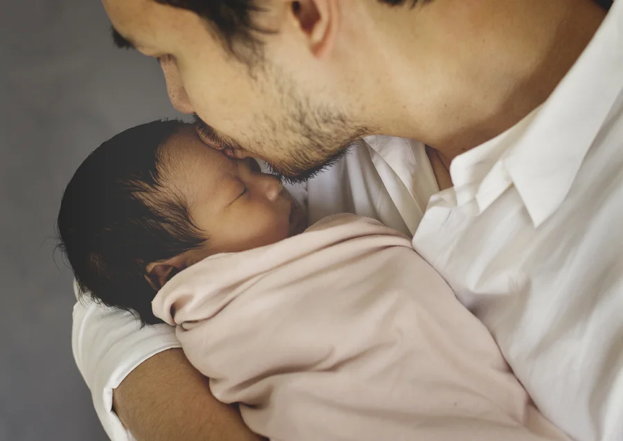 Dad kissing his newborn baby girl!