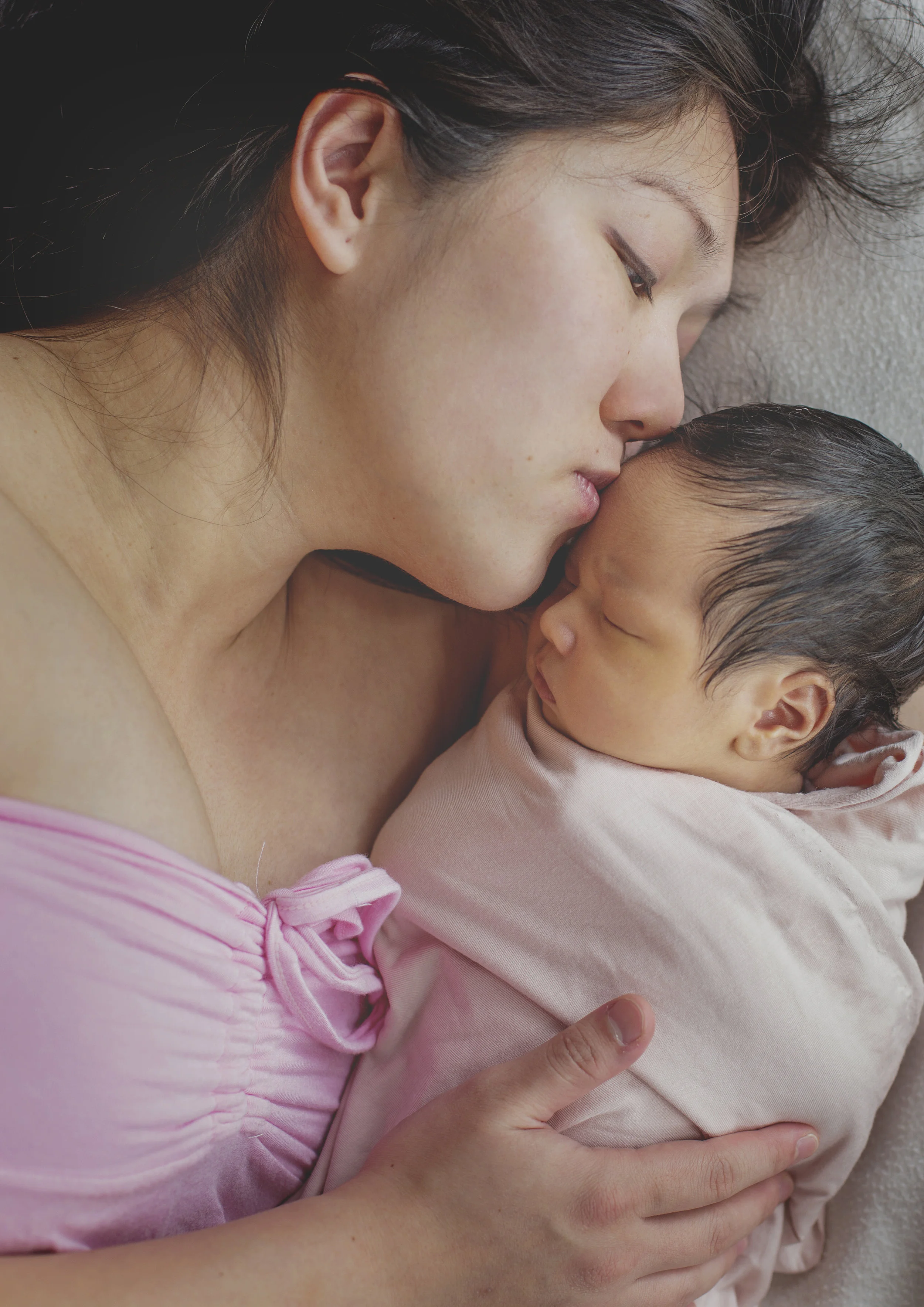 Mother kissing her newborn baby girl!