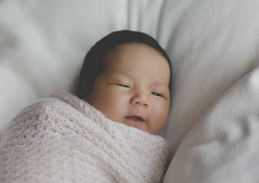 Smiling newborn baby girl