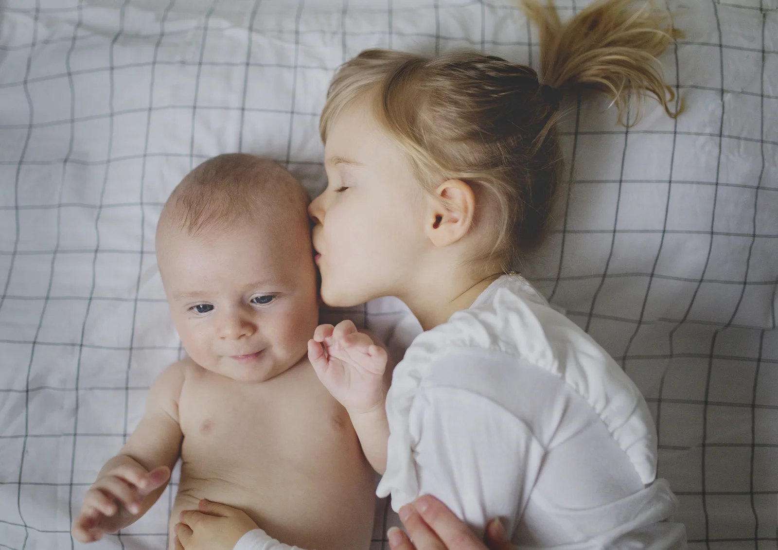 Big Sister kissing her little brother!