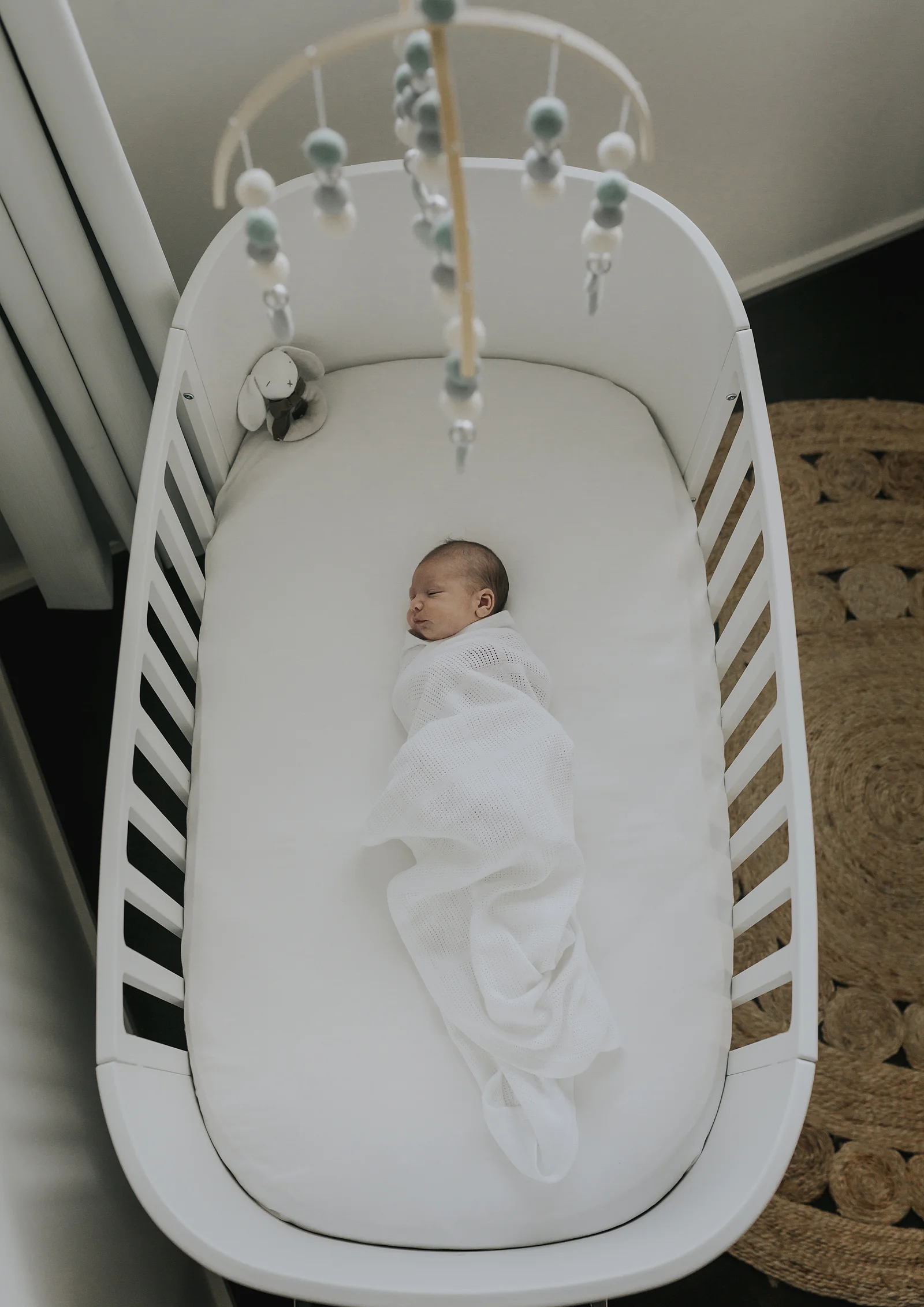 Newborn baby boy in his cot