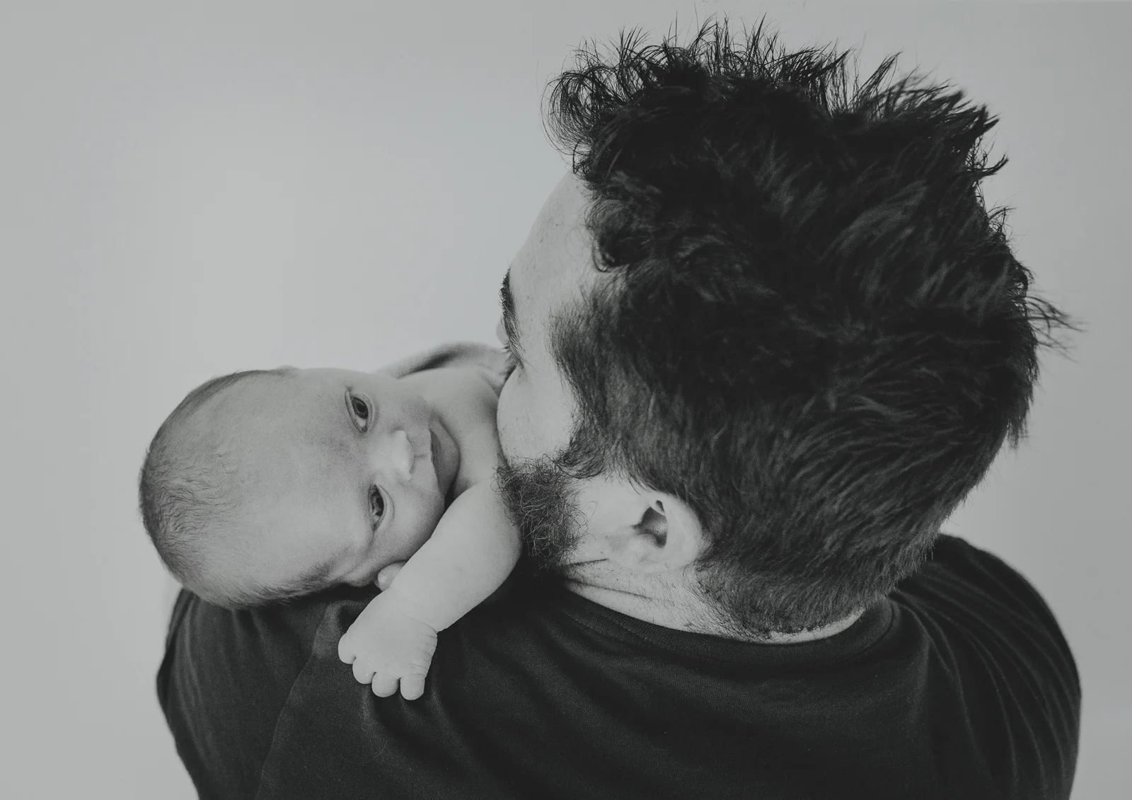 Dad holding his newborn baby son