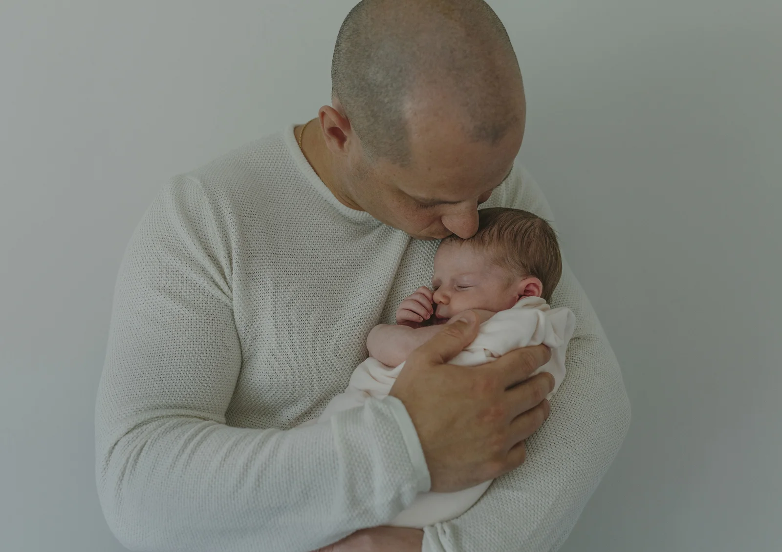 New Dad cuddling his newborn baby girl
