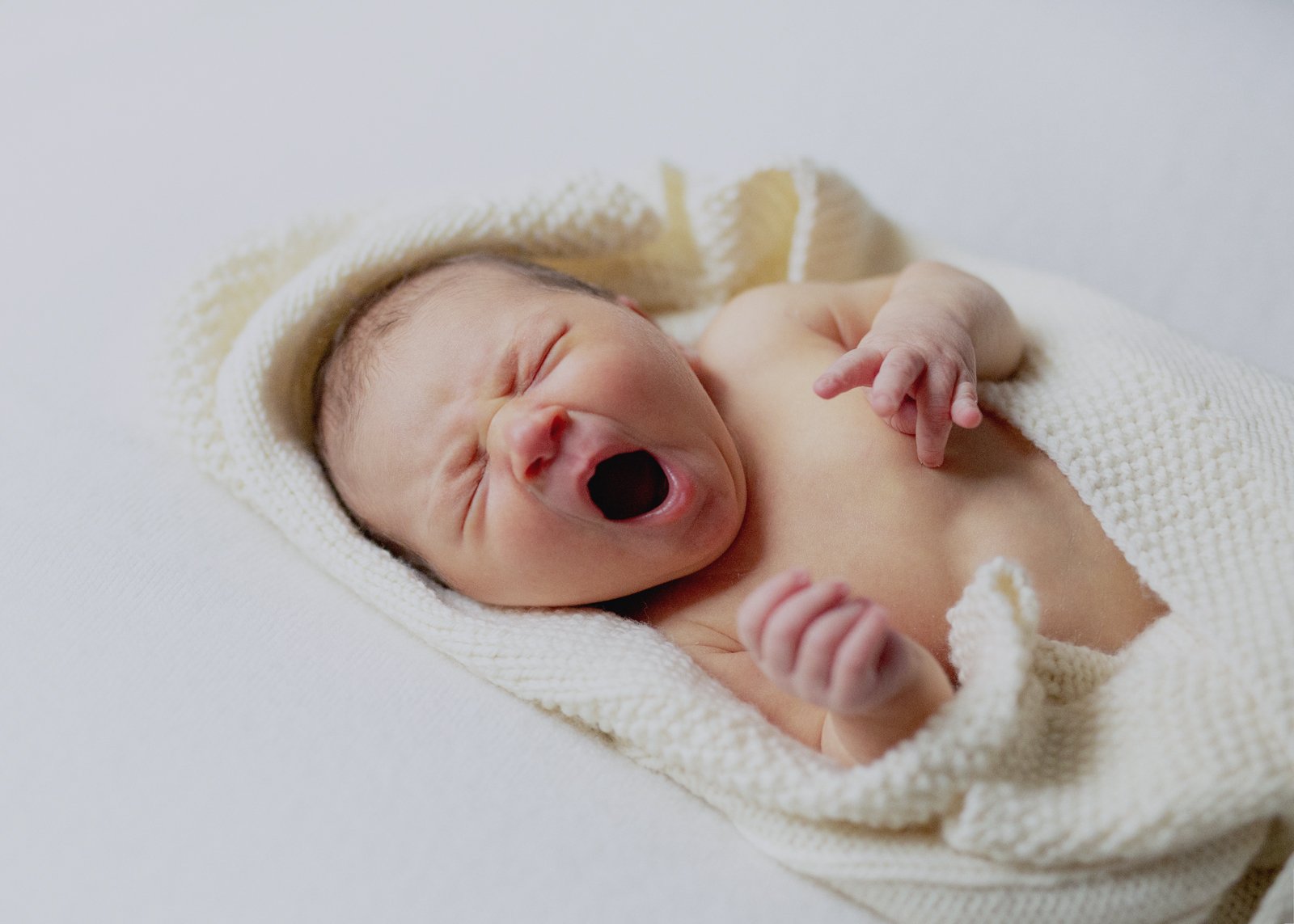 Newborn baby girl yawning