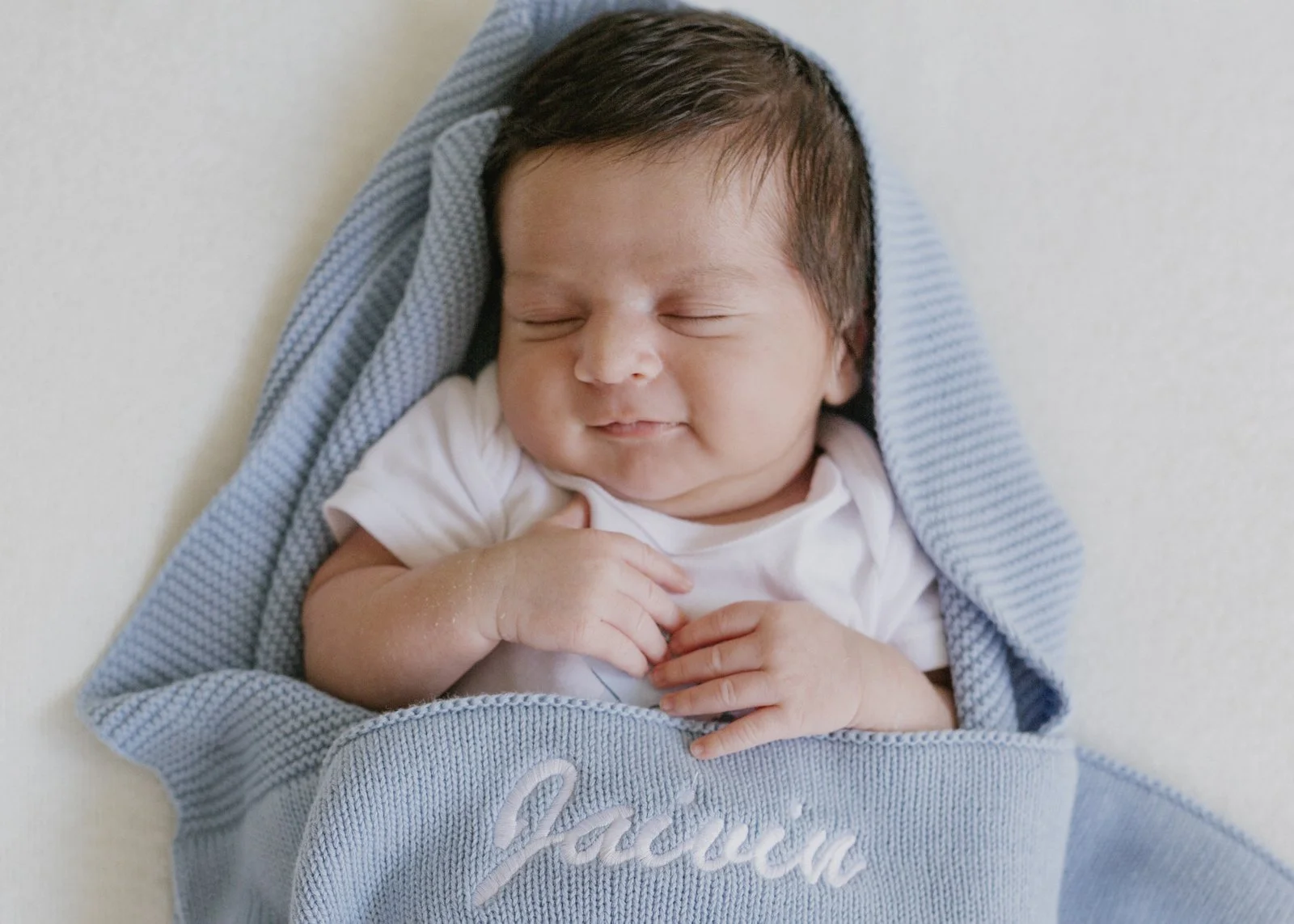 Smiling newborn baby boy