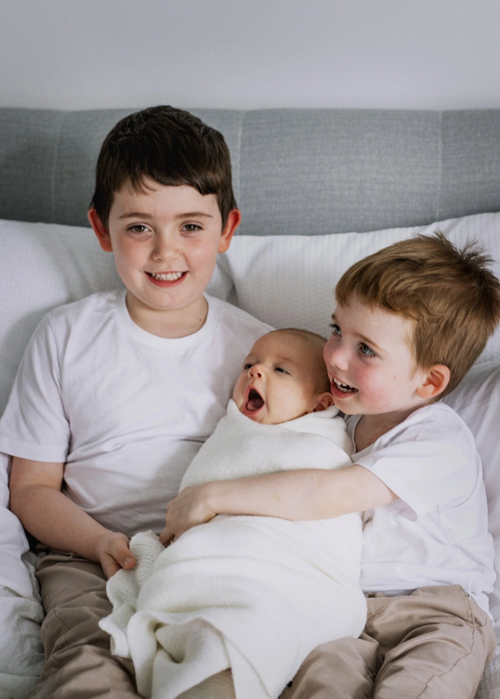 2 month old baby girl with her older brothers2 month old baby girl with her older brothers