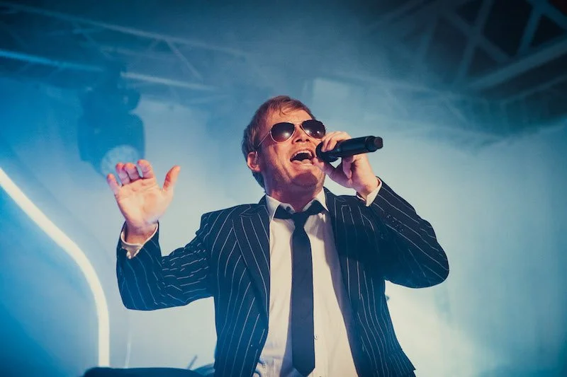 zanger in kostuum op verjaardagsfeest