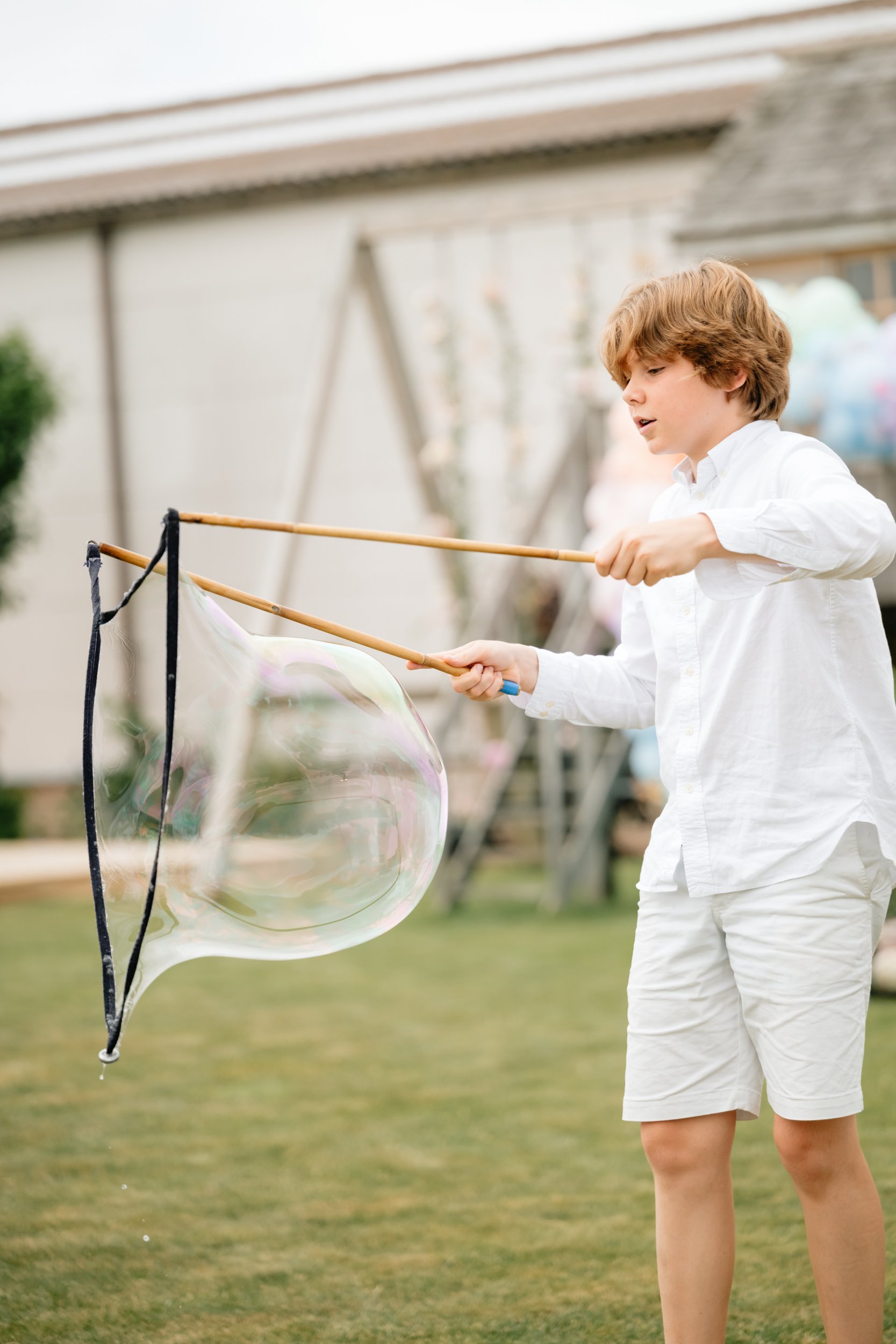 jongen die grote bellen maakt met bellenblazer