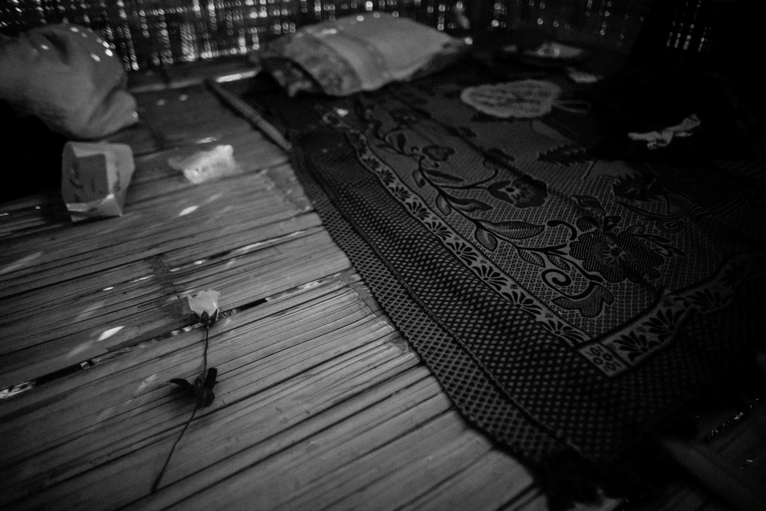 An artificial rose left besides the bed of one of the students at Aung Mintha. Roses were given to the students after a choir performance in the village.