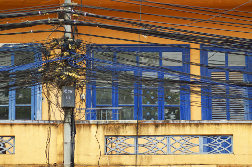 a-tangle-of-cables-and-wires-on-front-of-window.png