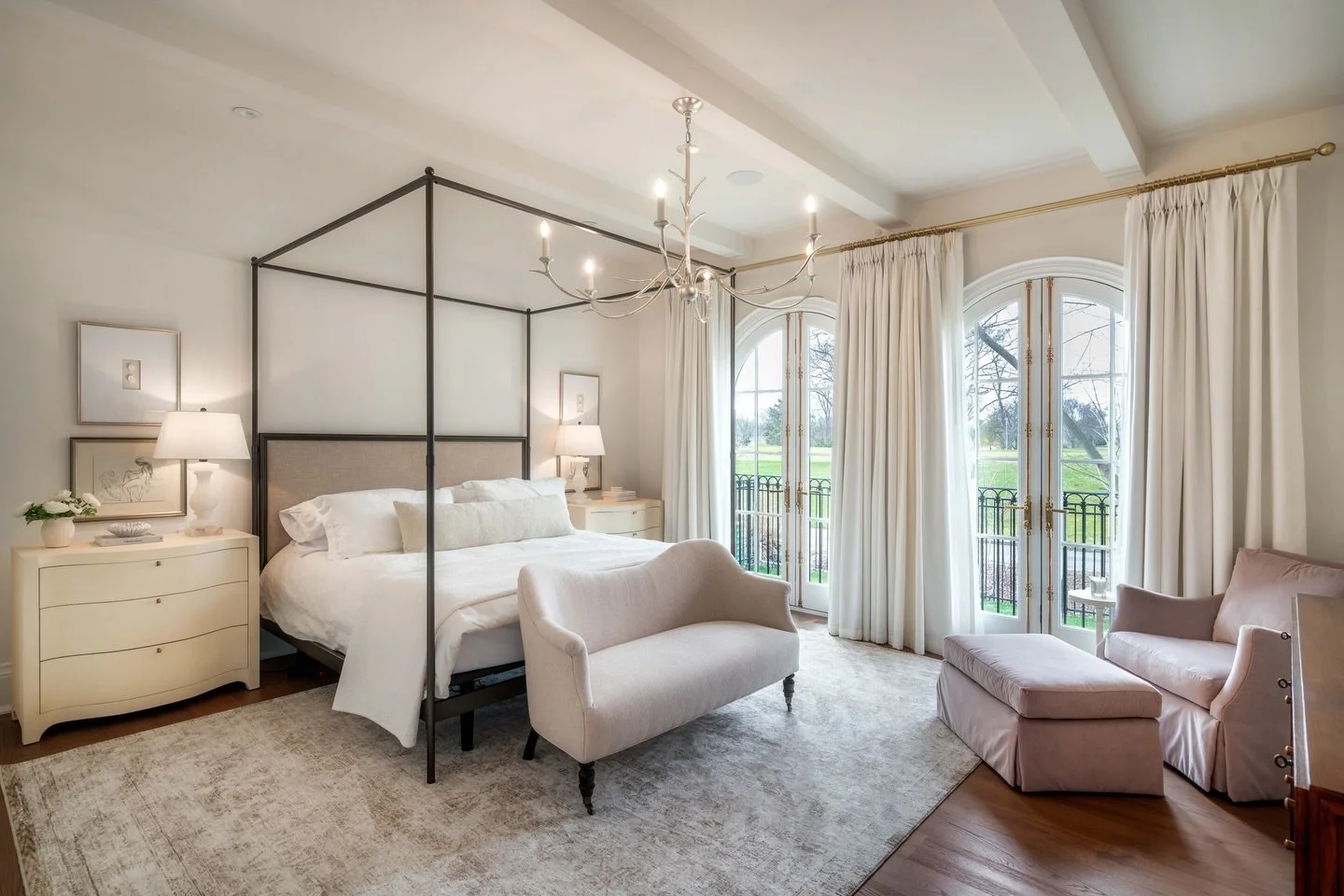 This Georgian inspired primary suite was built to feel like a true retreat. Soft morning light through arched doors, layered neutrals, and proportions that just feel right. The ensuite carries that same quiet calm, making it the perfect space to slow