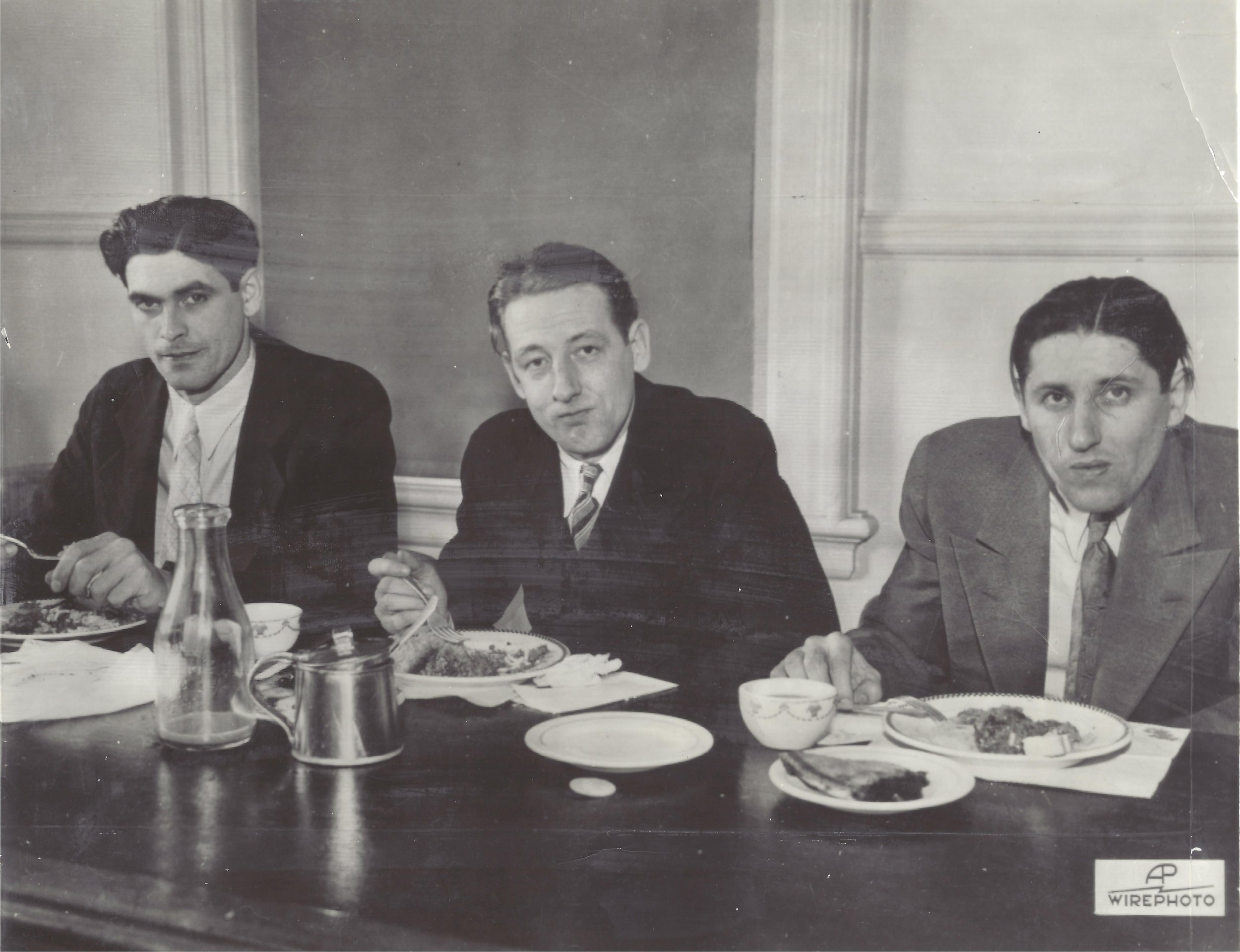 The second photo shows (left to right) convicts Alex McKay, Joe Kristy and Fred Launders eating lunch during a break in their trial. Landers plead guilty during the trial and the other two were tried under the Lindberg law as they kidnapped a prison guard.