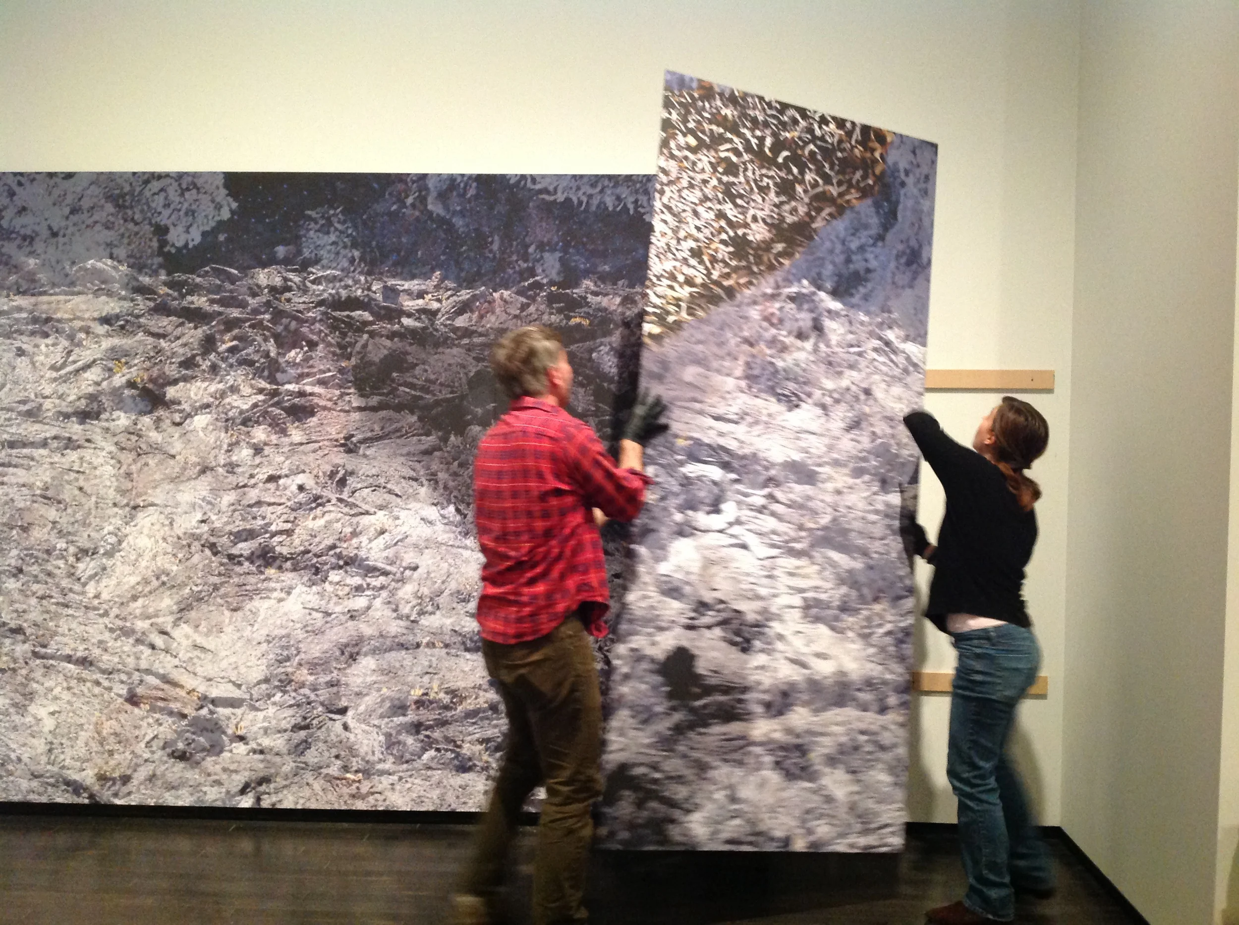  Gallery Preps Clint Wilson and Jennifer Smith moving one of the panels into place. 