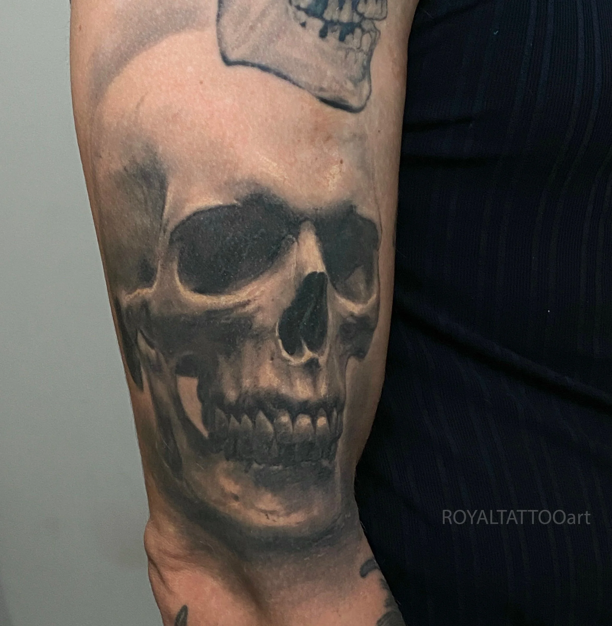 Black and grey skull realism tattoo with strong contrast, smooth shading, and detailed texture, tattooed on the Lower East Side.
