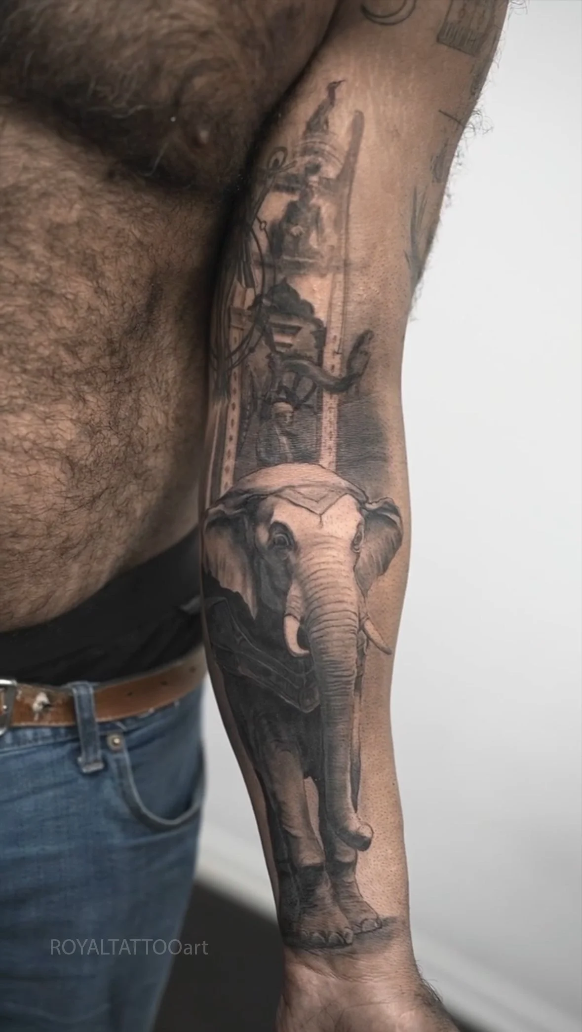 Black and grey realism tattoo featuring an elephant clock with Arabic lettering, inspired by historical design and tattooed on the Lower East Side.