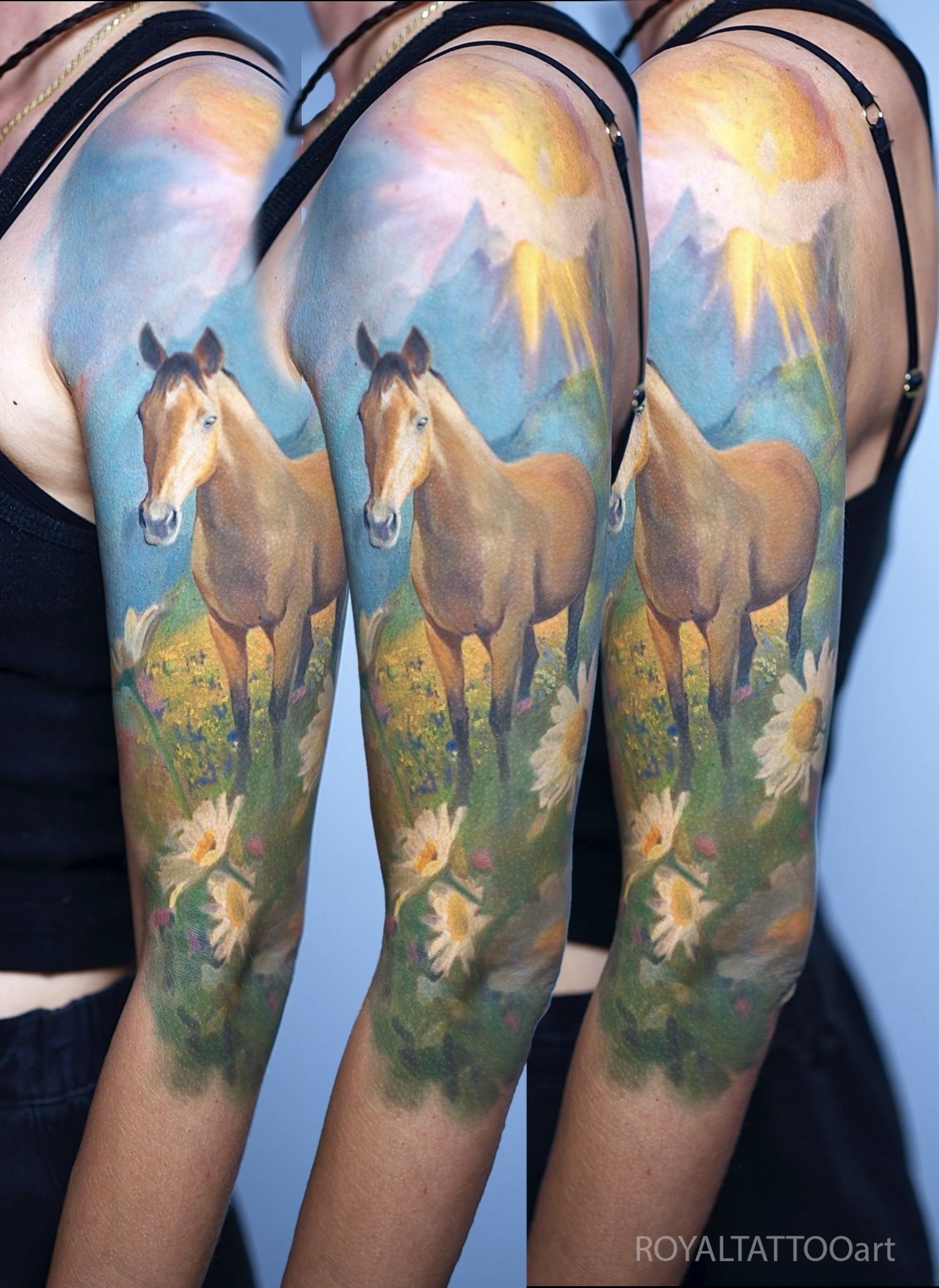 Breathtaking color horse landscape tattoo sleeve on the arm, created in NYC. This vibrant scene showcases horses in a lush natural setting, tattooed with Royal Tattoo Art's signature color realism technique — ideal for equine lovers seeking a dramati